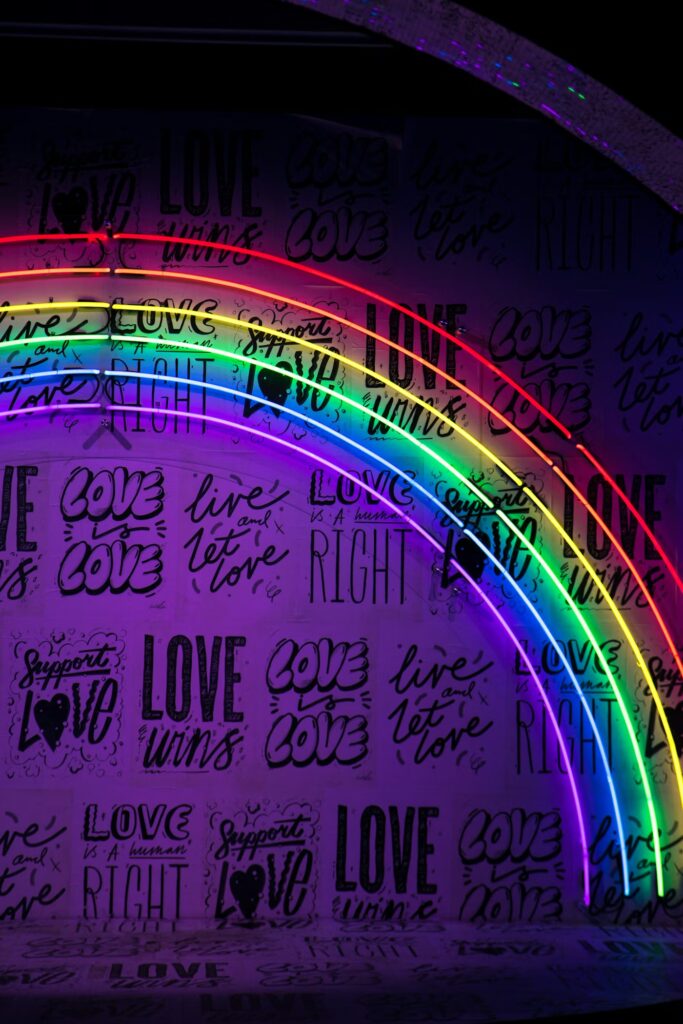image of a rainbow on a purple wall with pride inspirational quotes